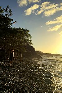 Walking along a beach at sunset