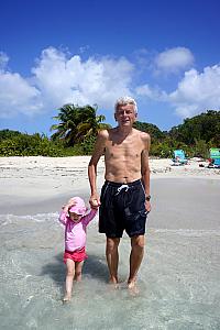 Capri and grandpa walking in the water.