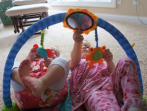 Kenley and Capri playing with Miles' toys.