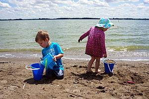 Cooper and Capri playing in the sand