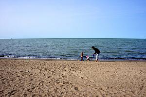 Capri and Kenley playing in the sand with Mimi