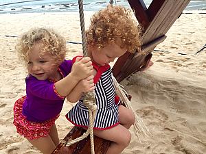 Capri pushing Kenley on the swing