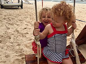 Capri pushing Kenley on the swing