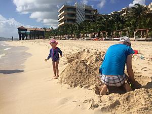 Dad and Capri are building a big sand castle!