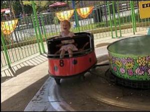 At Kings Island! Riding her favorite ride, the ladybug / whip.