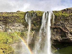 Fun rainbow in front of Seljalandsfoss waterfall.